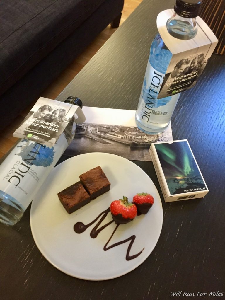 a plate of dessert and water bottles on a table