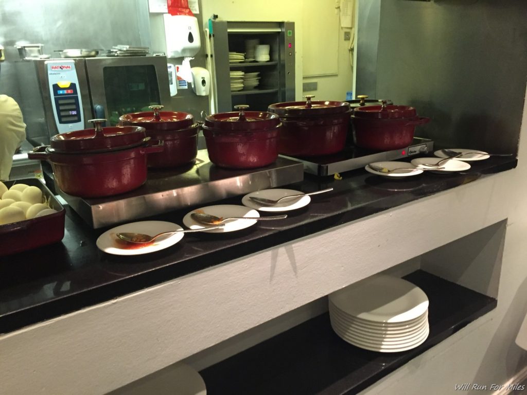 a group of red pots on a counter top
