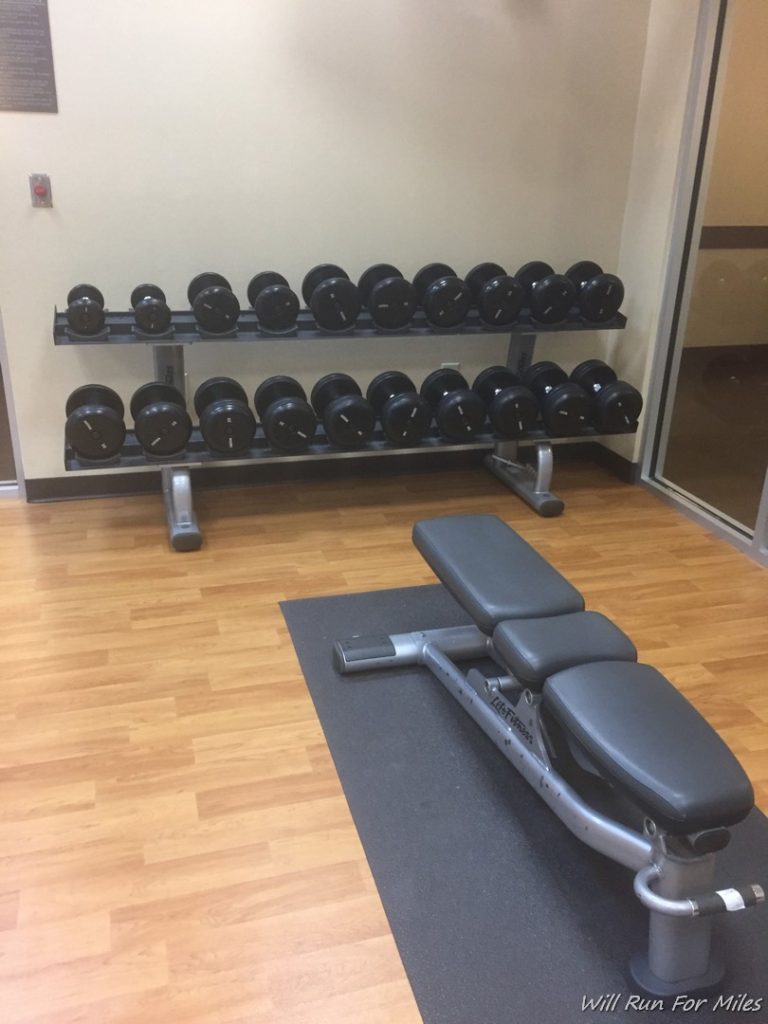 a gym with weights on the floor