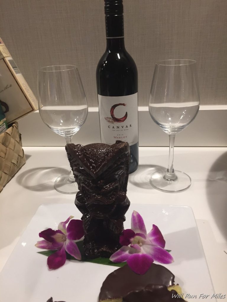 a bottle of wine and a statue on a plate