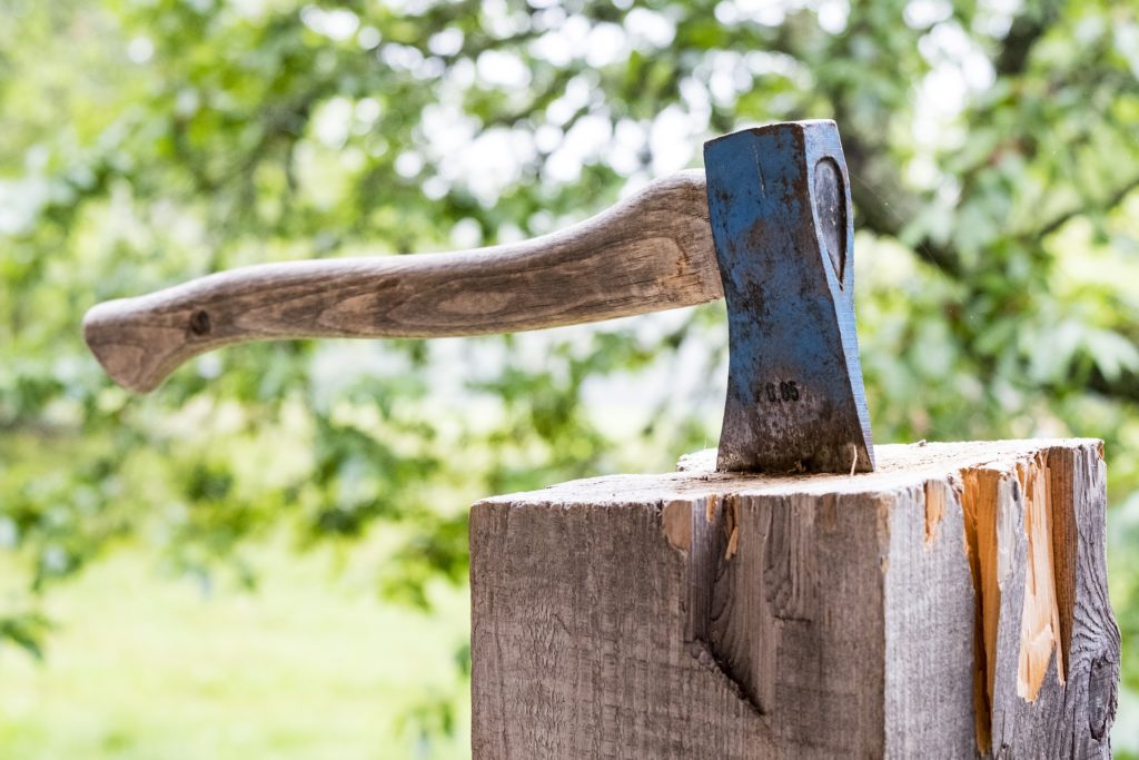 an axe stuck in a wood block