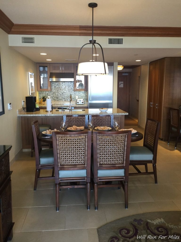 a dining room with a kitchen and dining table