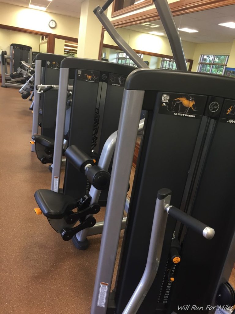 a group of exercise machines in a gym