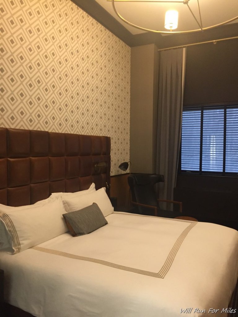 a bed with a brown headboard in a room