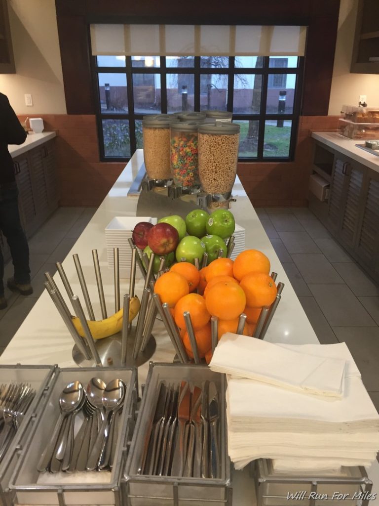 a buffet table with fruit and spoons