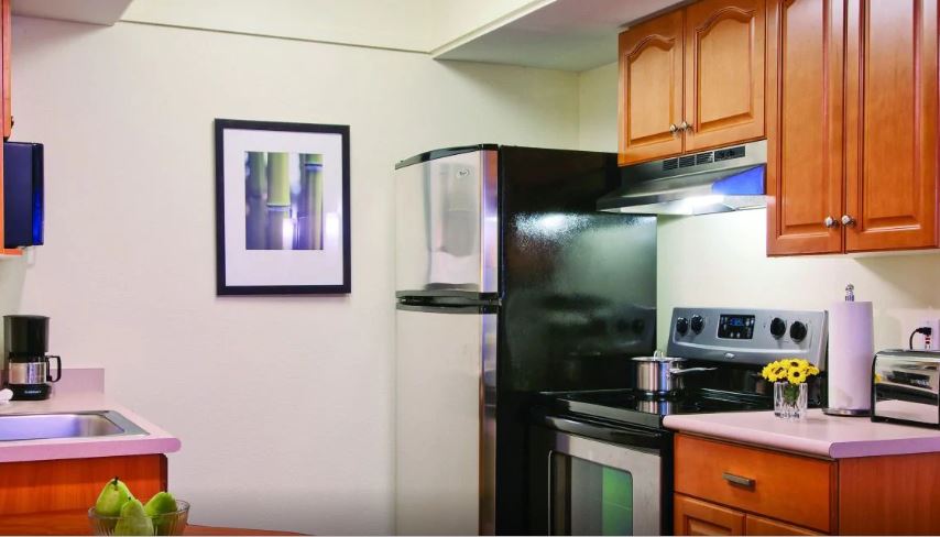 a kitchen with a refrigerator and stove
