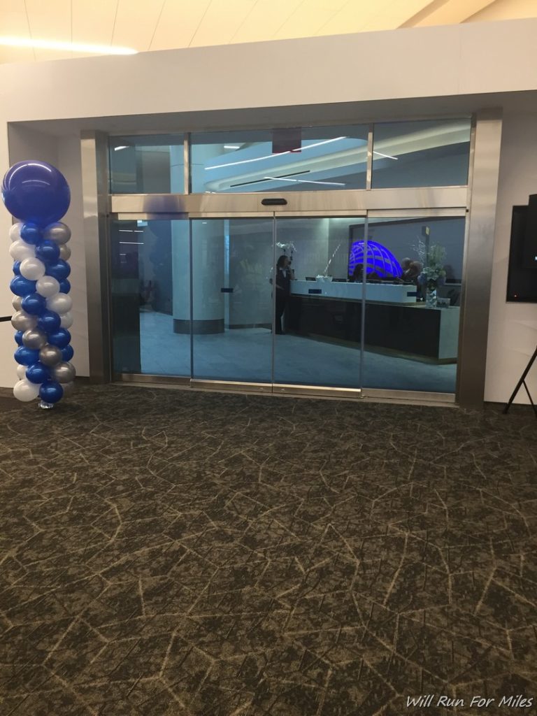a glass door with a large column of balloons