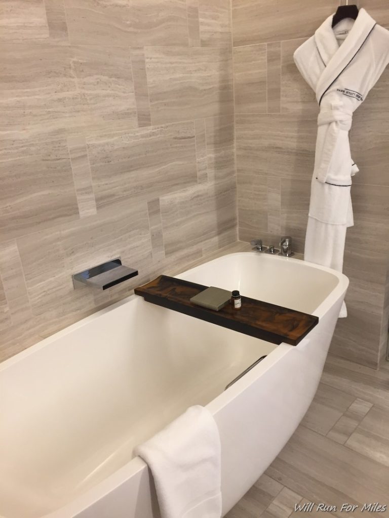 a bathtub with a towel on the tray