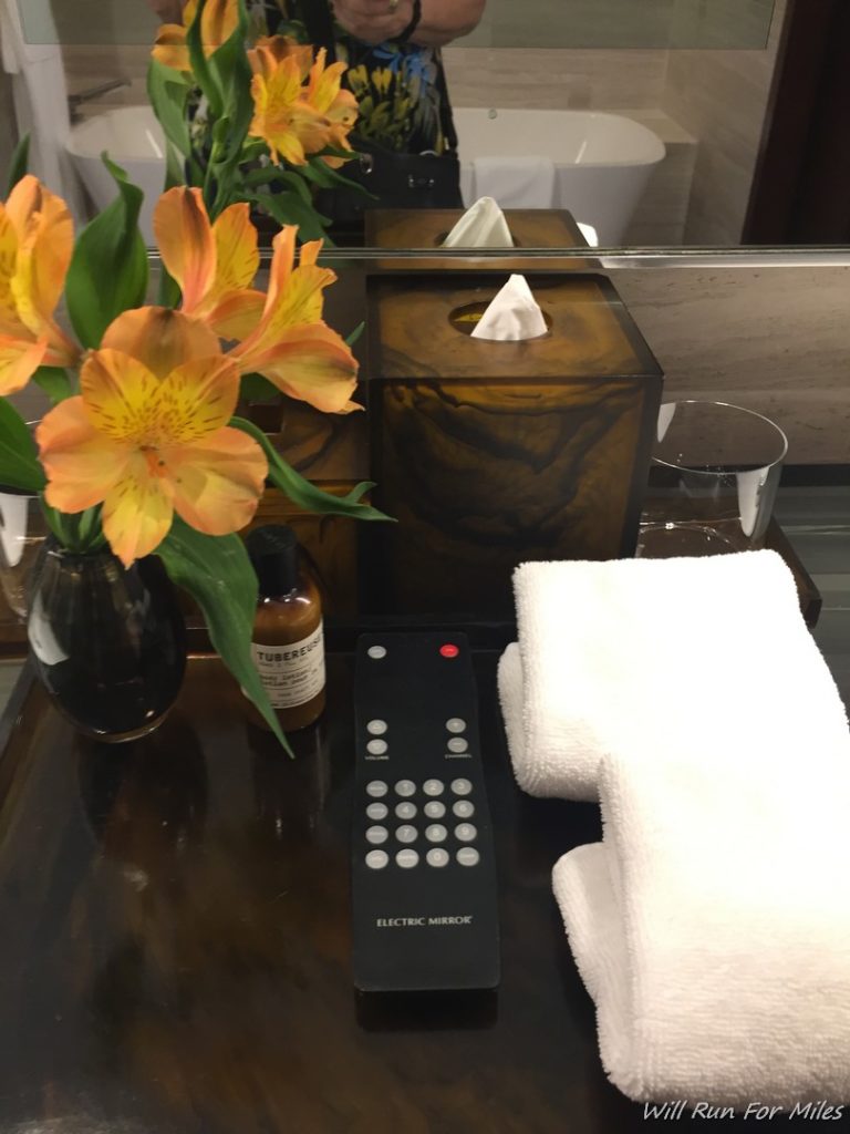 a remote control and towels on a table