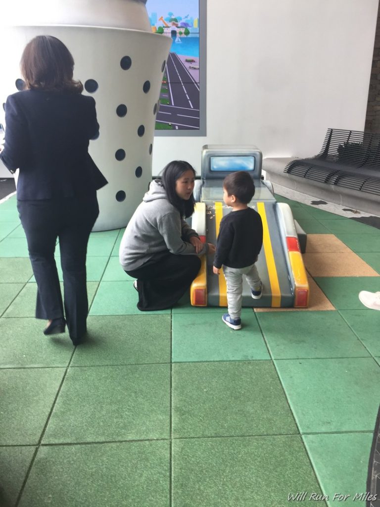 a woman and a boy playing with a toy