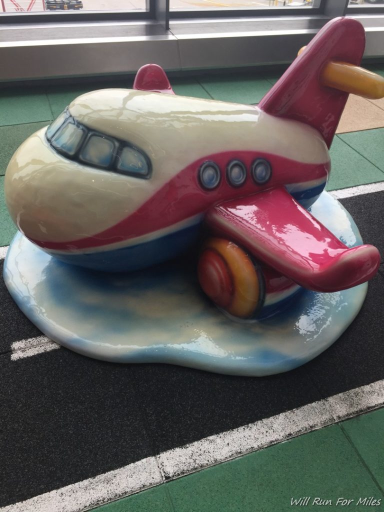 a statue of a pink and white airplane