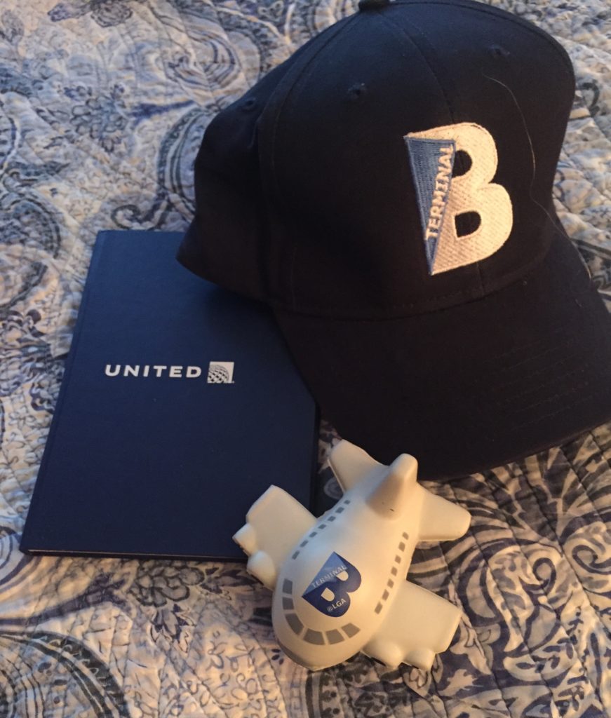 a hat and toy airplane on a bed