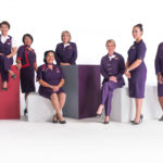 a group of women in purple uniforms