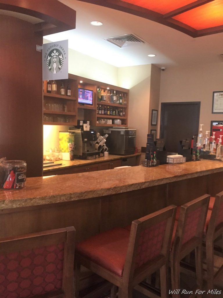 a bar with chairs and a counter