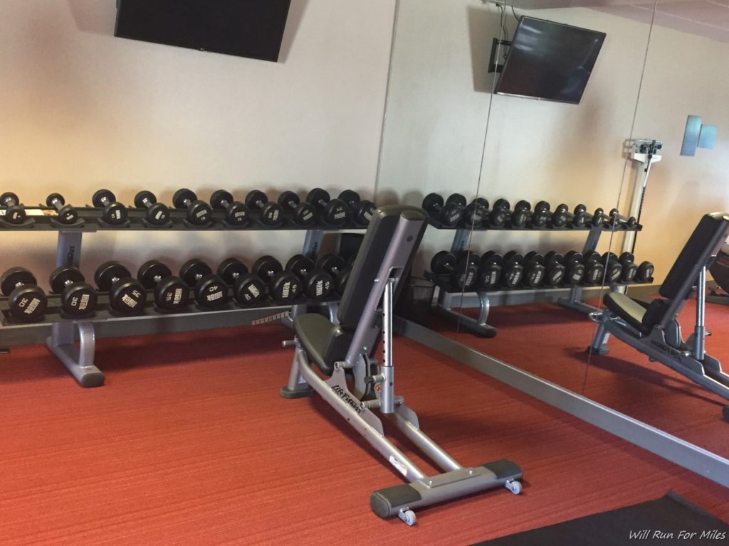 a gym with weights and a television