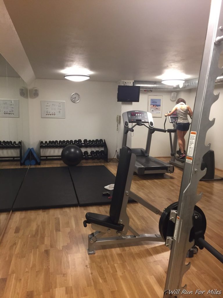 a woman standing on treadmills in a gym