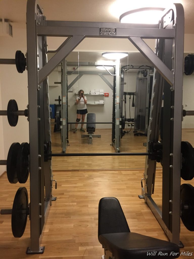 a mirror of a gym with weights