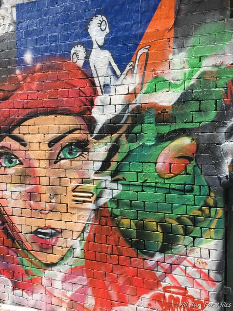 a mural of a woman and a cat