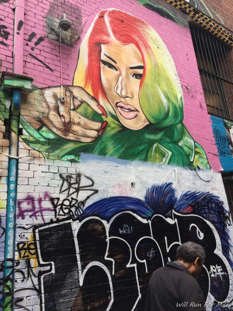 a mural of a woman with red hair and green hair