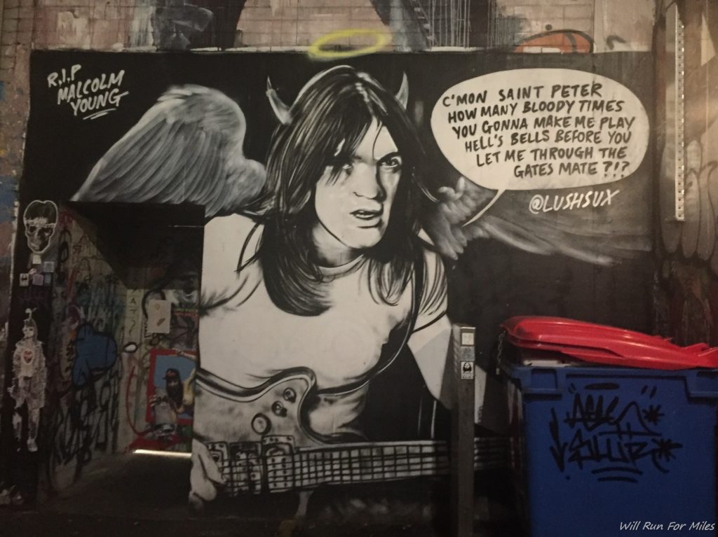 a mural of a man with wings and a guitar