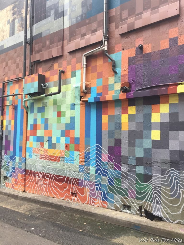 a wall with colorful squares and lines painted on it