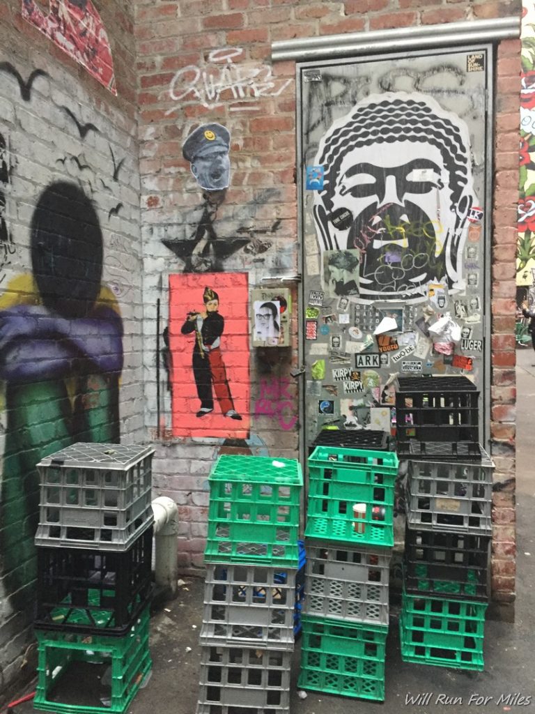 a wall with a brick wall and a stack of crates