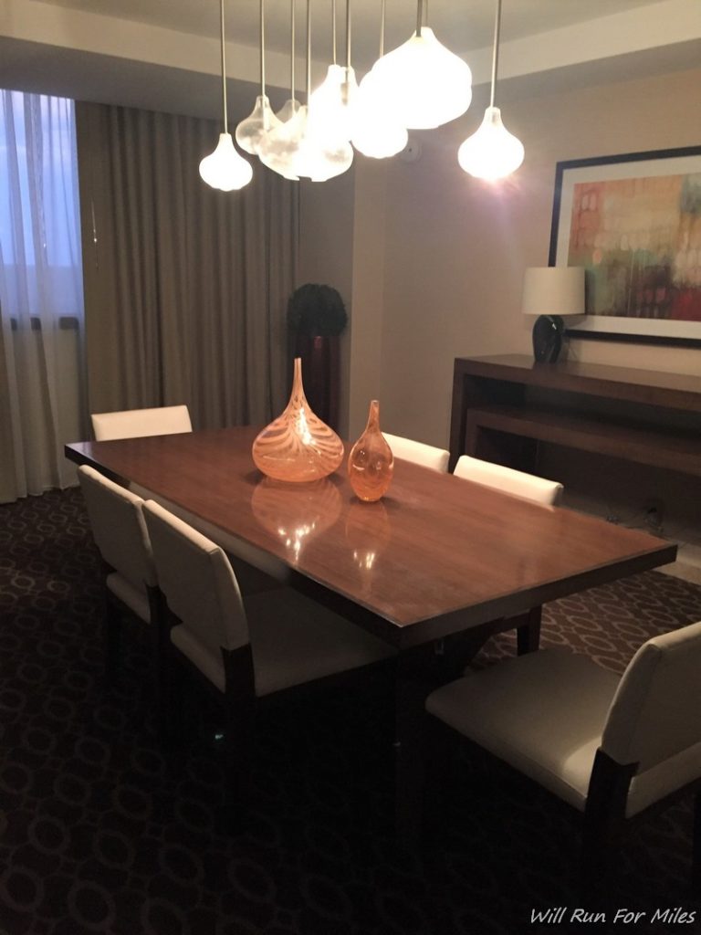 a table with chairs and a lamp