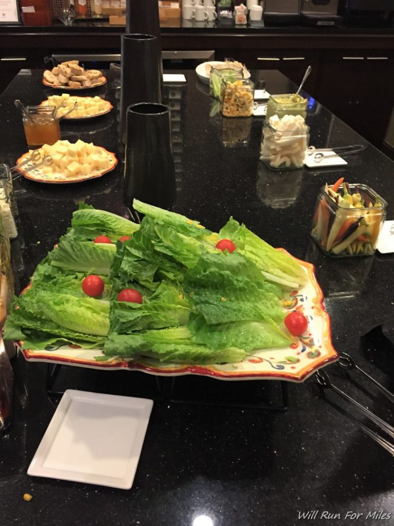 a plate of lettuce and tomatoes on a table