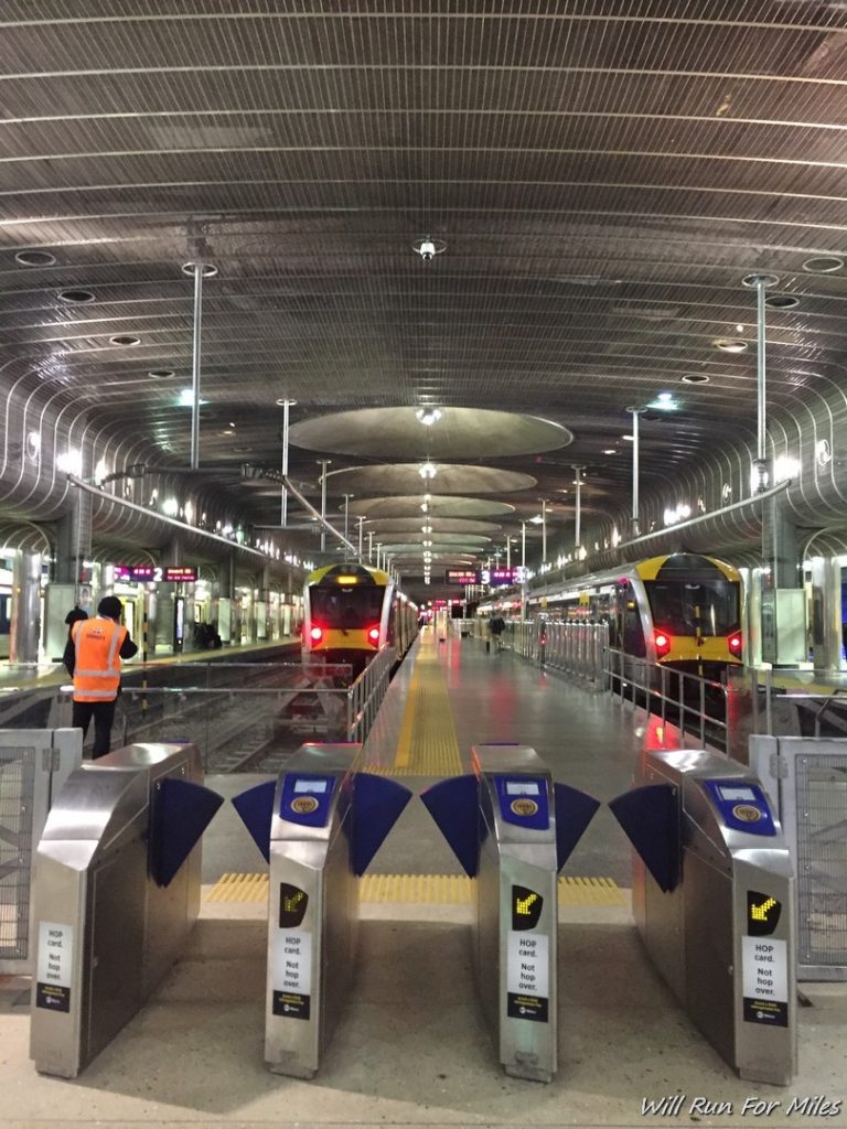 a train station with a train and a man standing in front of it