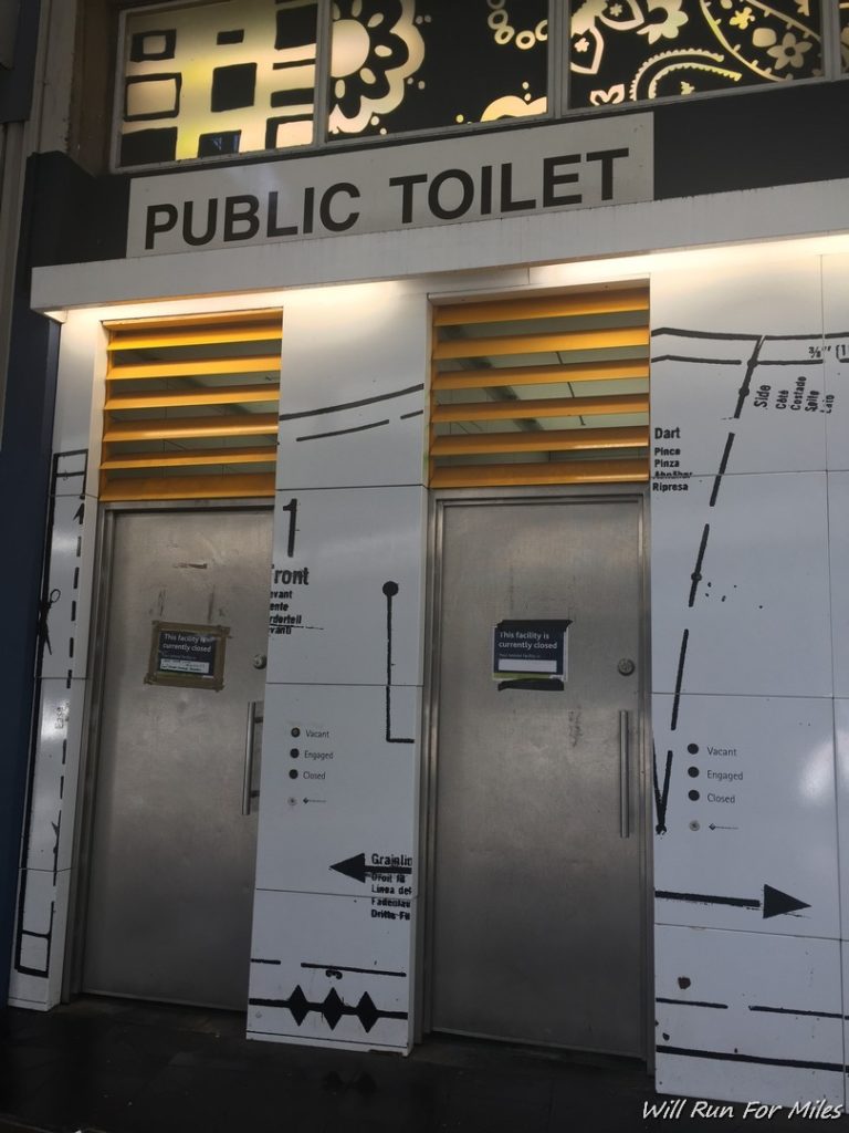 a public toilet with a sign