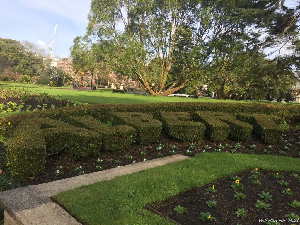 a green hedge with letters in the middle of a park