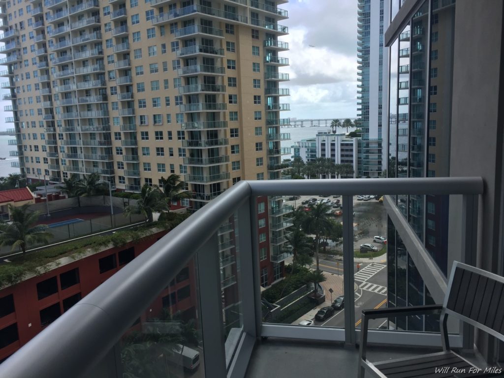 a balcony with a railing and a city view