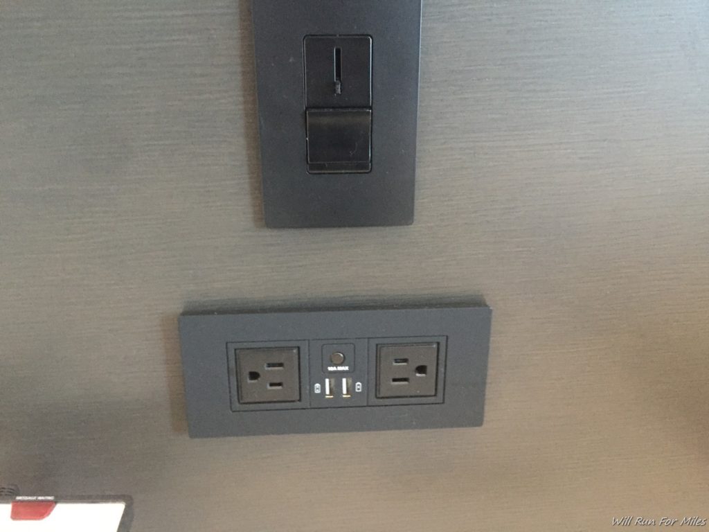 a black rectangular outlet and a black rectangular outlet on a gray wall