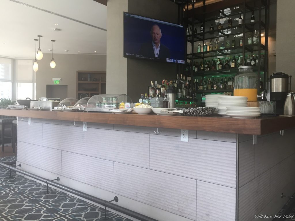 a bar with a television and shelves of bottles