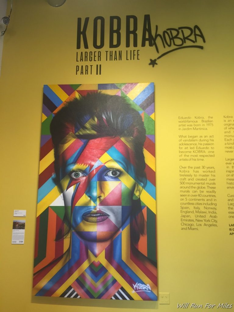 a poster of a woman on a yellow wall