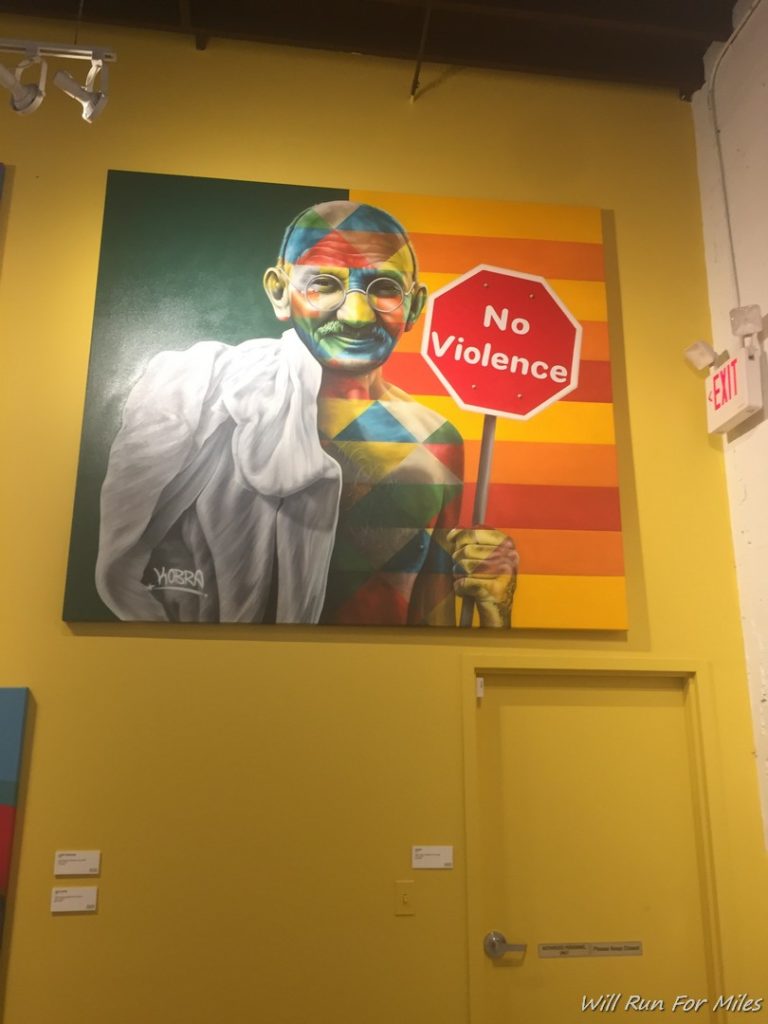 a painting of a man holding a sign
