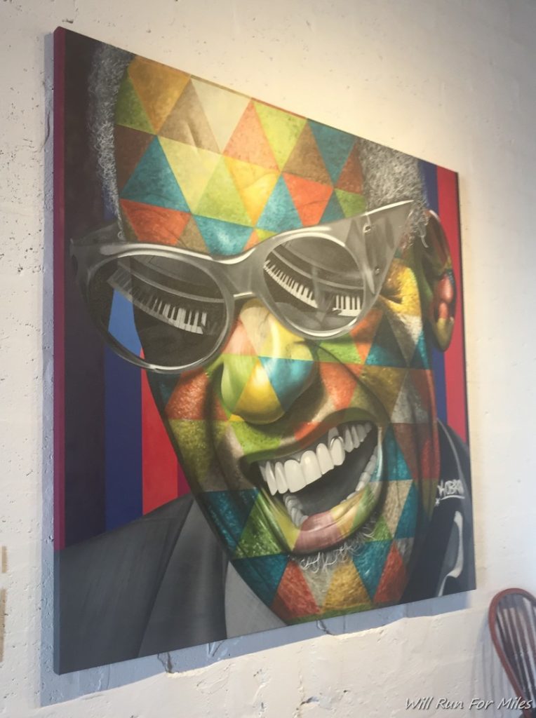 a painting of a man with sunglasses on a wall