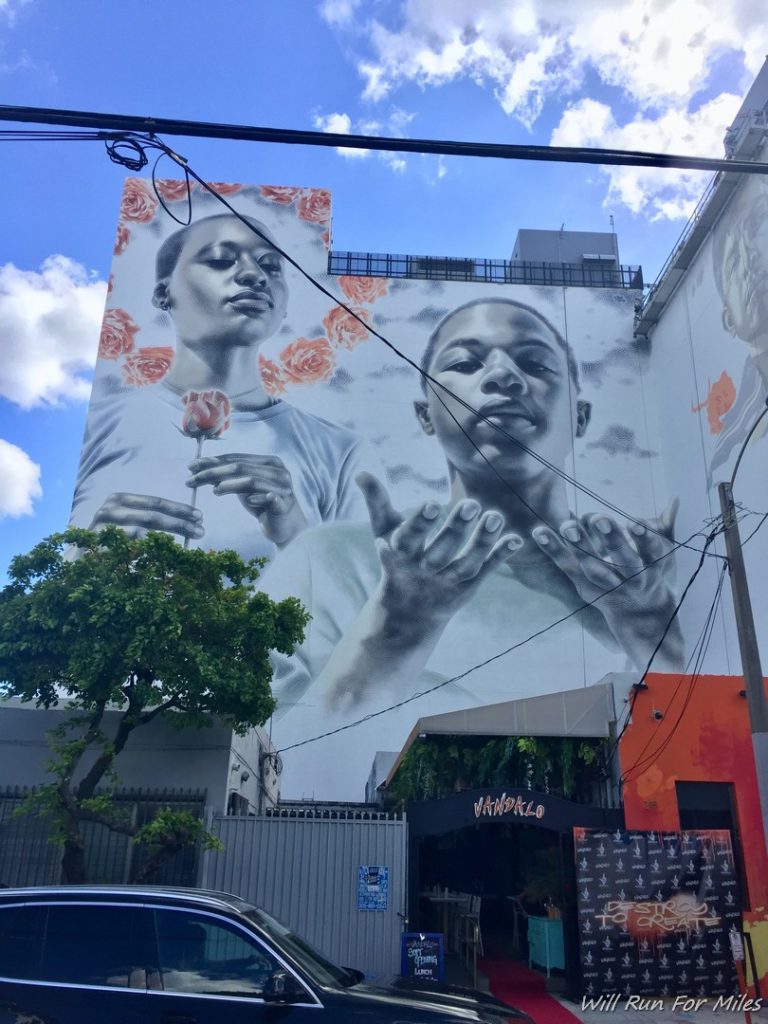 a mural of a couple of men holding a rose