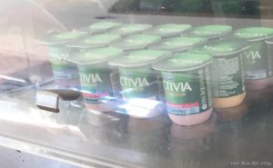 a group of yogurt containers in a case