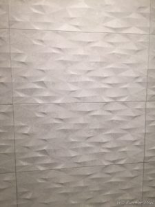 a white tile with a triangular pattern