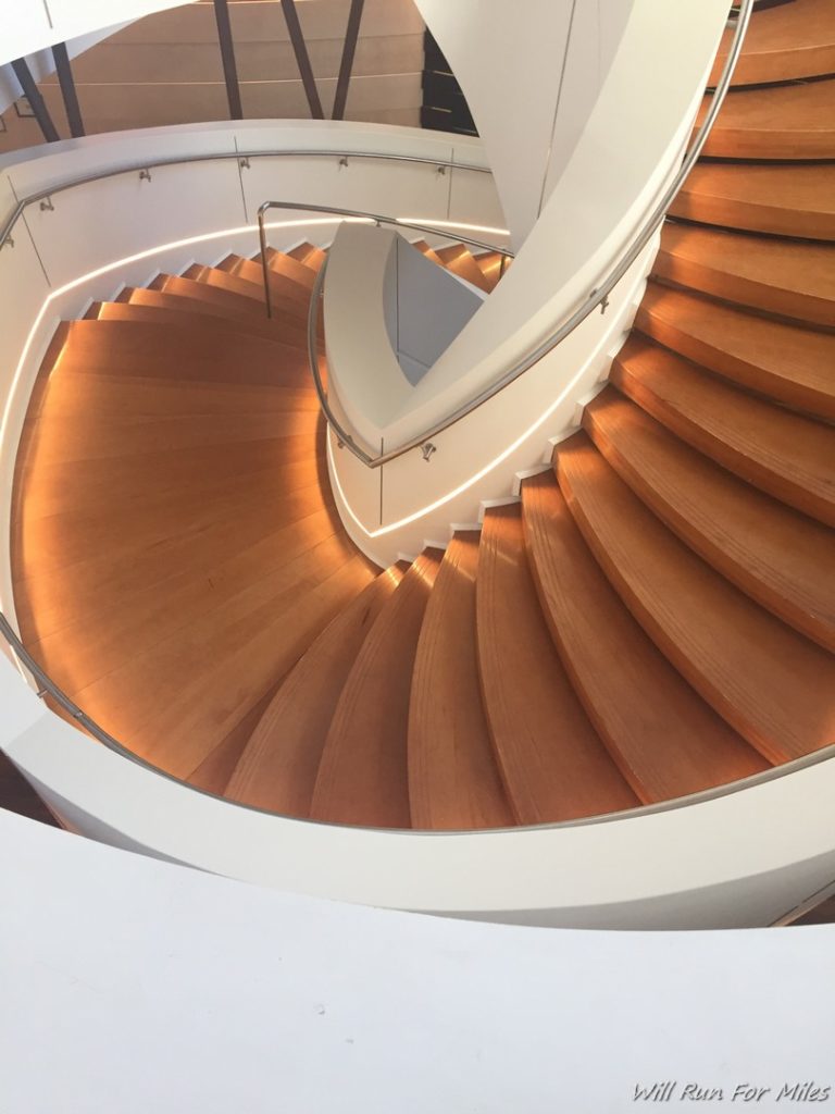 a spiral staircase with light on the side