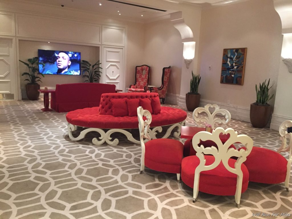 a room with red couches and chairs