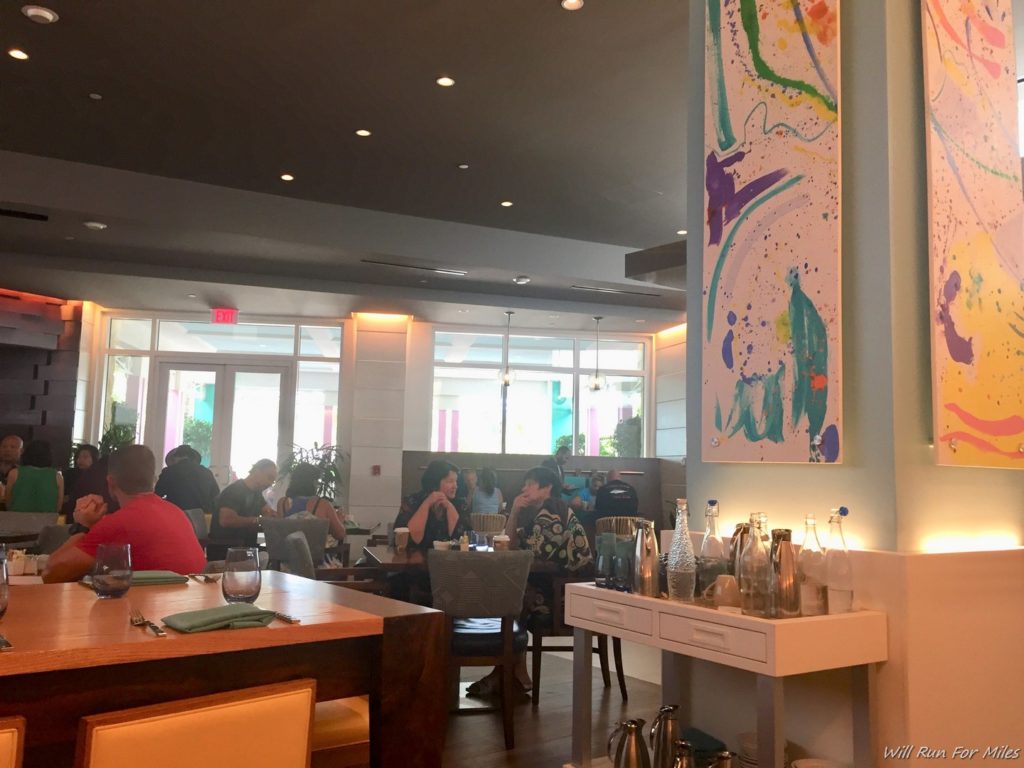 a group of people sitting at tables in a restaurant