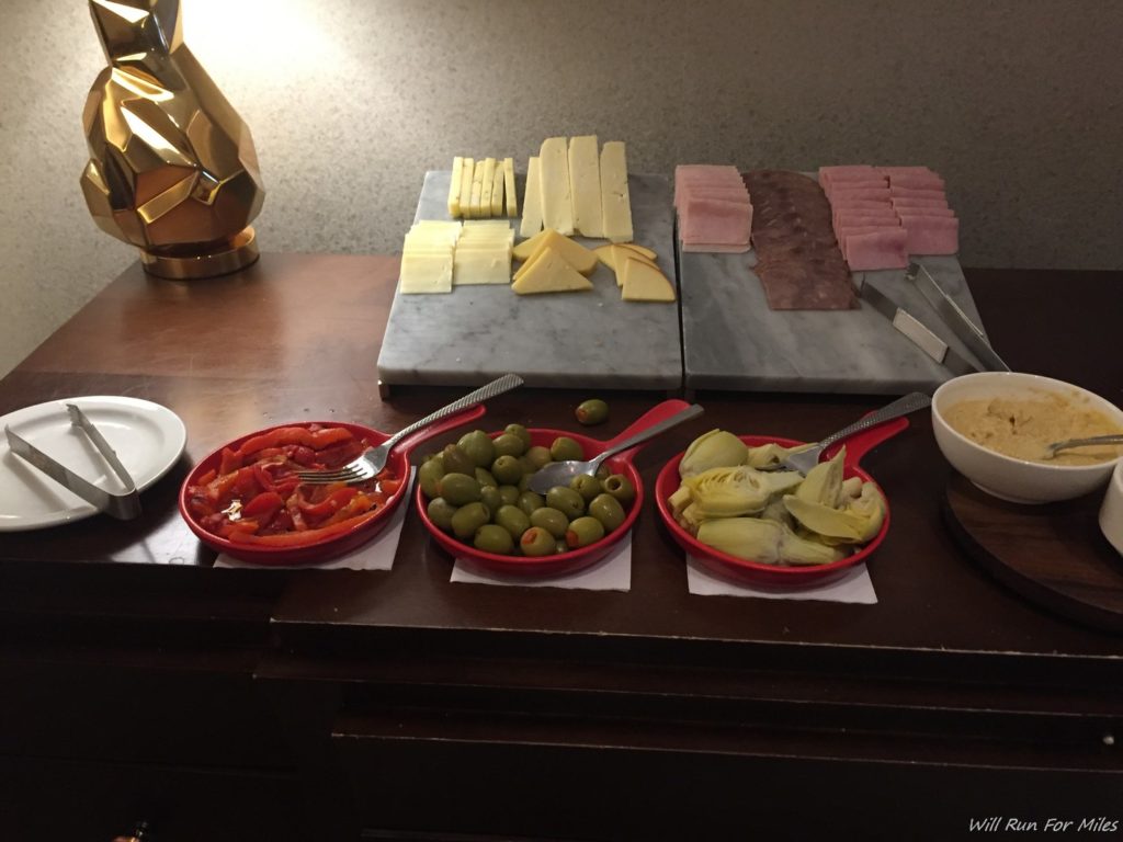 a table with plates of food and plates of cheese and meat