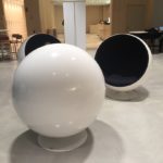 a group of white balls with black cushion