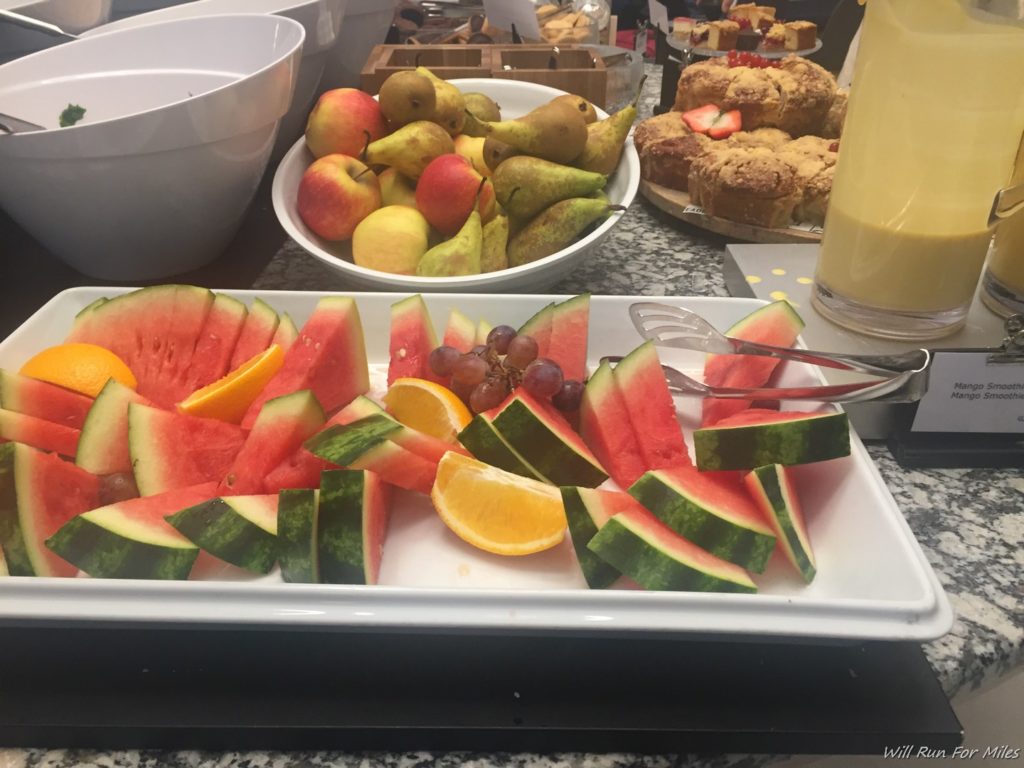 a plate of fruit and a glass of juice