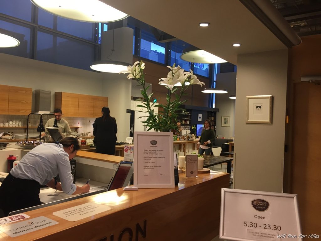 a counter with a sign and people behind it