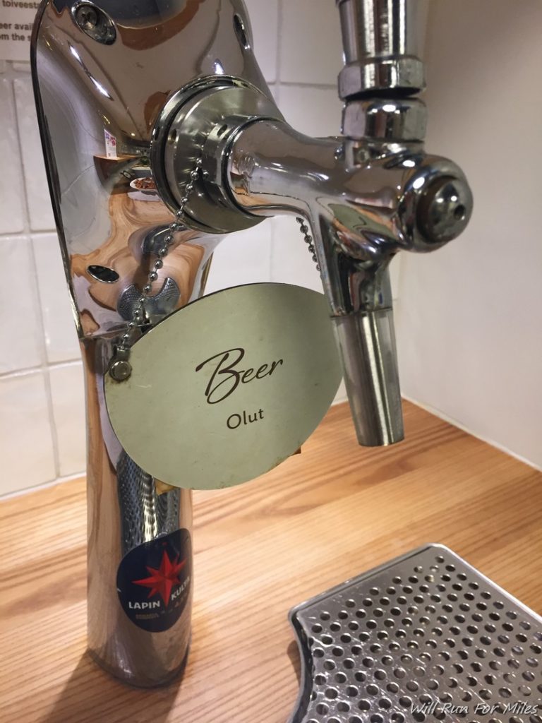 a silver beer tap on a wood surface