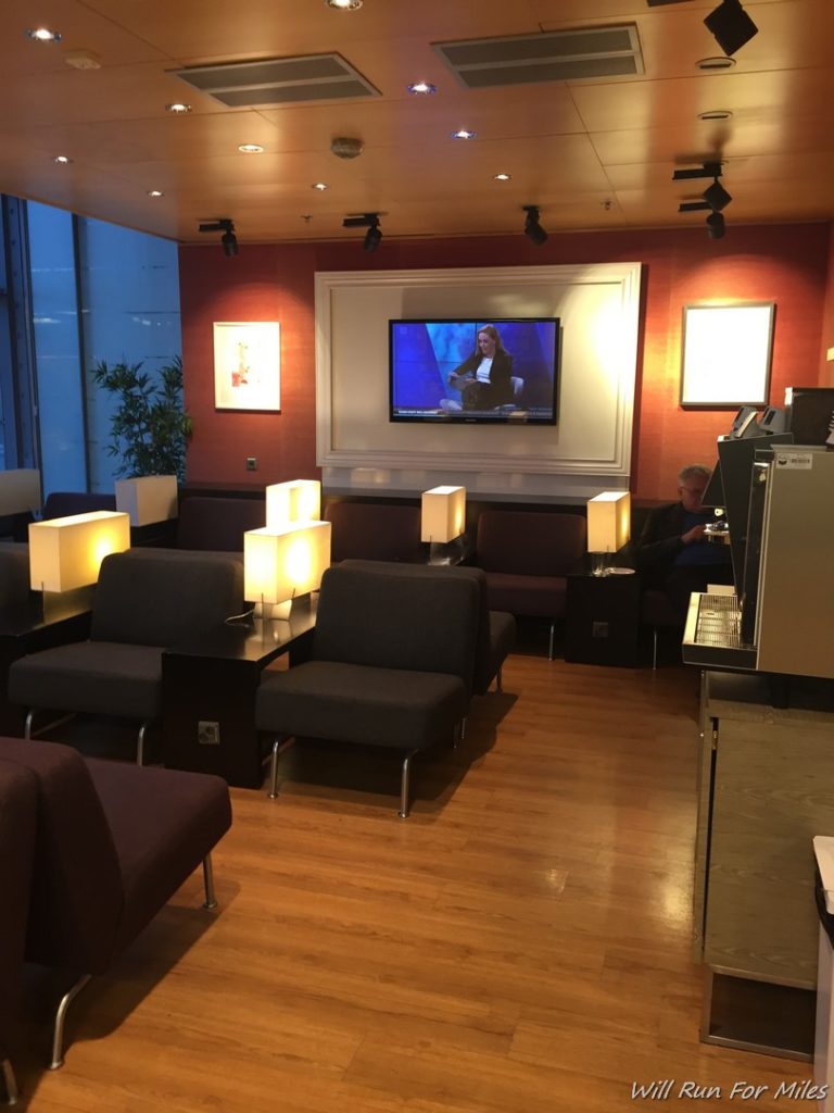 a room with a television and chairs
