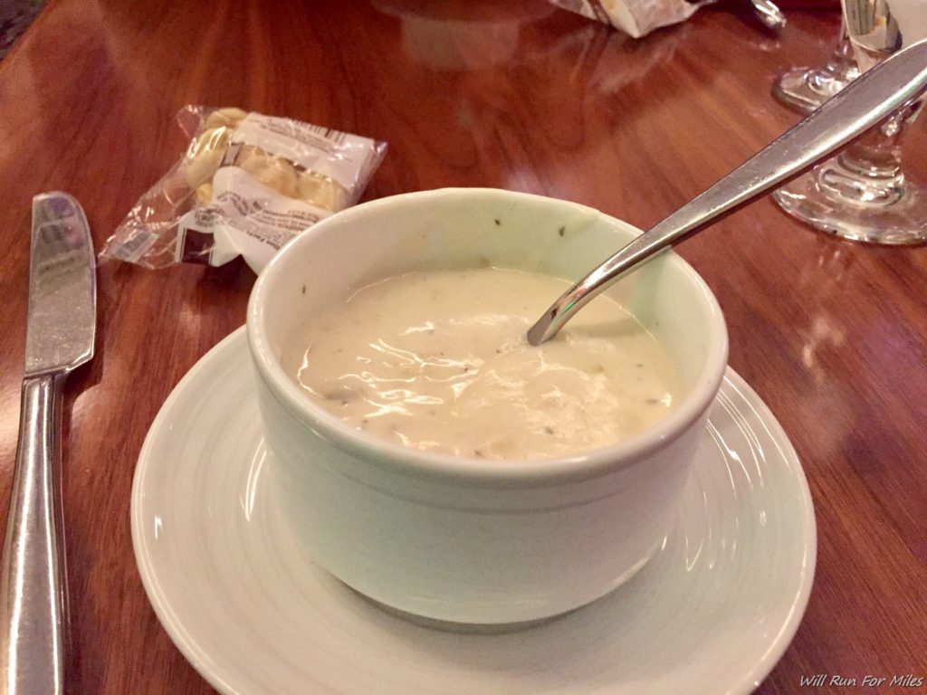 a bowl of soup with a spoon on a plate